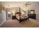 Well-lit main bedroom features a four poster bed, neutral color palette and access to the deck at 11691 Riverdale Dr, Parker, CO 80138