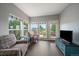 Cozy sunroom with multiple windows, comfortable seating, and a view of the backyard at 11691 Riverdale Dr, Parker, CO 80138