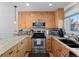 Bright kitchen with stainless steel appliances, granite countertops, light wood cabinetry and modern lighting at 2308 Hearth Dr # 36, Evergreen, CO 80439
