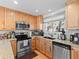 Kitchen showcasing stainless steel appliances, granite counters, light wood cabinets, and updated fixtures at 2308 Hearth Dr # 36, Evergreen, CO 80439