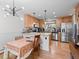 Bright kitchen with stainless appliances, light wood cabinets, and modern lighting with an eat-in area at 2308 Hearth Dr # 36, Evergreen, CO 80439