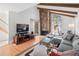 Inviting living room with a floor-to-ceiling stone fireplace, exposed wood beams, and natural light at 2308 Hearth Dr # 36, Evergreen, CO 80439