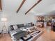 Open-concept living room with vaulted ceilings, exposed wood beams, and an adjacent kitchen and dining area at 2308 Hearth Dr # 36, Evergreen, CO 80439