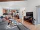 Spacious living room with vaulted ceilings, hardwood floors, and views into the modern kitchen at 2308 Hearth Dr # 36, Evergreen, CO 80439