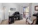 Office space with a desk, computer setup, and sliding glass door leading to a balcony at 2308 Hearth Dr # 36, Evergreen, CO 80439