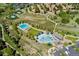 Aerial view of community pool, recreational amenities, walking paths, and lush green space at 9117 Nambe Trl, Lone Tree, CO 80124