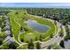 Scenic aerial view of the neighborhood showcasing a golf course, a lake, and well-maintained residential areas at 9117 Nambe Trl, Lone Tree, CO 80124