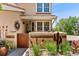 A charming entryway boasts a private gated area with desert landscaping and unique decorative elements at 9117 Nambe Trl, Lone Tree, CO 80124