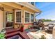 Inviting front porch with decorative mat, chairs, plants, and tiled accents offers a cozy welcome at 9117 Nambe Trl, Lone Tree, CO 80124
