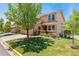 Charming townhome features a landscaped front yard with mature trees and desert landscaping at 9117 Nambe Trl, Lone Tree, CO 80124