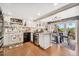 Well-lit kitchen with island, stainless steel appliances, and a dining area with access to balcony at 9117 Nambe Trl, Lone Tree, CO 80124