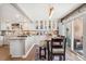 Open kitchen and dining area with white cabinets, granite countertops, and access to outdoor space at 9117 Nambe Trl, Lone Tree, CO 80124