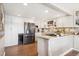 Modern kitchen with white cabinetry, stainless steel appliances, granite countertops, and ample storage space at 9117 Nambe Trl, Lone Tree, CO 80124