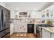 Bright kitchen features white cabinets, stainless steel appliances, granite countertops and charming rooster accents at 9117 Nambe Trl, Lone Tree, CO 80124