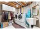 Functional laundry room with modern washer and dryer, storage cabinets, and ample space for tasks at 9117 Nambe Trl, Lone Tree, CO 80124