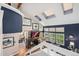 Vaulted living room with skylights, fireplace and adjacent dining room at 9117 Nambe Trl, Lone Tree, CO 80124