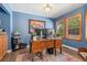 Well-lit home office with hardwood floors, built-in shelving, large windows, and classic wooden desk at 9117 Nambe Trl, Lone Tree, CO 80124