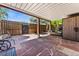 Outdoor patio with red flagstone, garden decor, and wood fence offers a serene space for relaxation and entertainment at 9117 Nambe Trl, Lone Tree, CO 80124