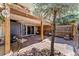 Charming outdoor patio area featuring flagstone flooring, wood accents, and a cozy ambiance with leafy shade at 9117 Nambe Trl, Lone Tree, CO 80124