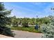 Neighborhood street view featuring mature trees, community signage, and well-maintained landscaping at 9117 Nambe Trl, Lone Tree, CO 80124