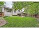 Home's backyard includes a lawn, a garden, and a partially covered patio with outdoor seating and a grill at 6443 S Florence Way, Englewood, CO 80111
