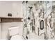 Shower stall featuring marble tiling, a black shower head, and a glass door at 6443 S Florence Way, Englewood, CO 80111