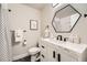 Bathroom featuring a shower with a geometric shower curtain, an accent mirror, and a white vanity at 6443 S Florence Way, Englewood, CO 80111