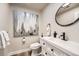 Bathroom featuring an accent mirror, a modern sink, and a wood-look floor at 6443 S Florence Way, Englewood, CO 80111