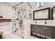 Bathroom featuring a glass shower with marble tiling and a dual sink vanity at 6443 S Florence Way, Englewood, CO 80111