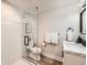Modern bathroom featuring a glass enclosed shower, white tiles, and a marble countertop at 6443 S Florence Way, Englewood, CO 80111