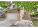 Charming two-story home with brick accents, concrete steps to the front door, and a two-car garage at 6443 S Florence Way, Englewood, CO 80111