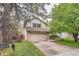 Charming two-story home with a well-maintained lawn and a two-car garage in a mature neighborhood at 6443 S Florence Way, Englewood, CO 80111