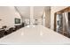Bright kitchen with an expansive marble island, stainless steel appliances, and an open-concept floor plan at 6443 S Florence Way, Englewood, CO 80111