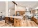 Spacious kitchen with vaulted ceilings, wood cabinets, stainless steel appliances, and a large island at 6443 S Florence Way, Englewood, CO 80111