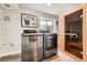 Modern laundry room with stainless steel washer and dryer set and a sauna in the same room at 6443 S Florence Way, Englewood, CO 80111