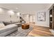 Living room with a sectional couch, built-in cabinets, and hardwood floors at 6443 S Florence Way, Englewood, CO 80111