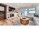 Cozy living room featuring a fireplace, TV, and a sliding glass door to the patio at 6443 S Florence Way, Englewood, CO 80111