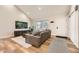 Cozy living room featuring wood floors, neutral paint colors, a large window, and modern decor at 6443 S Florence Way, Englewood, CO 80111