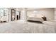 Spacious main bedroom with soft carpet and a view into the bathroom with a vanity at 6443 S Florence Way, Englewood, CO 80111