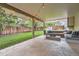Outdoor patio features a concrete foundation, outdoor seating, a wooden fence, and green grass at 6443 S Florence Way, Englewood, CO 80111
