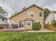 Backyard showcasing a well manicured lawn, a deck, and mature foliage at 285 N Holcomb St, Castle Rock, CO 80104