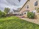A well manicured backyard with a grill, dining area, and green grass at 285 N Holcomb St, Castle Rock, CO 80104