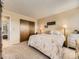 Spacious bedroom featuring plush carpeting, soothing wall colors, and a closet with sliding doors at 285 N Holcomb St, Castle Rock, CO 80104