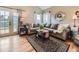 Comfortable living room with a sectional couch, hardwood floors, and large windows, offering an inviting atmosphere at 285 N Holcomb St, Castle Rock, CO 80104