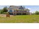A gorgeous house with an outdoor wooden deck and a meticulously maintained lawn at 3048 Deer Creek Ranch Loop, Parker, CO 80138