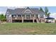 Spacious backyard with covered patio featuring stone columns and a seating area at 3048 Deer Creek Ranch Loop, Parker, CO 80138