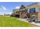 Spacious backyard features stone accents, a large deck, outdoor seating and a grill for outdoor enjoyment and entertaining at 3048 Deer Creek Ranch Loop, Parker, CO 80138