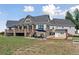 Covered backyard with a patio, a fire place, and a playground at 3048 Deer Creek Ranch Loop, Parker, CO 80138