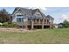 Backyard view, showing large windows, stone columns, covered patio, and ample yard space at 3048 Deer Creek Ranch Loop, Parker, CO 80138