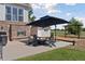 The patio with stone fireplace, outdoor seating, and a playset at 3048 Deer Creek Ranch Loop, Parker, CO 80138